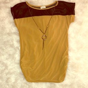 Large mustard colored shirt with attached jewelry